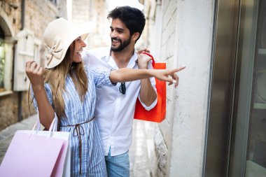 Mutlu iki turist yazın şehirde alışveriş yapıyor.