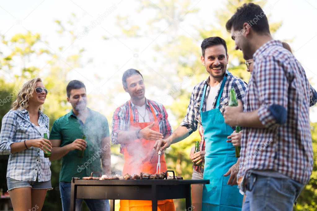 Friends having barbecue party in nature