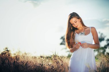 Genç, güzel, mutlu bir kadın doğada vakit geçiriyor.