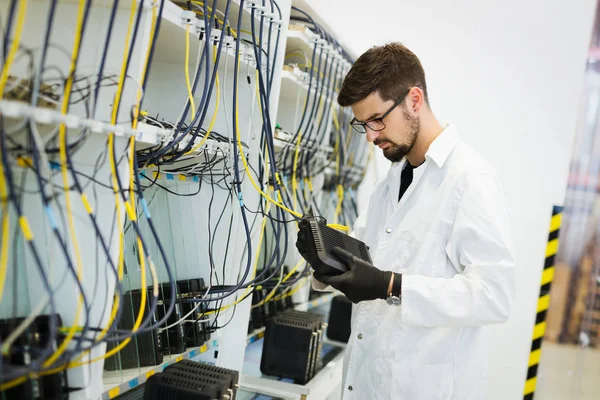 Picture of network technician engineer testing modems in factory