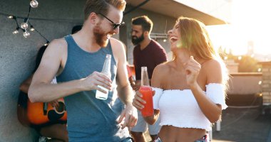 Bir grup arkadaş çatıdaki partide eğleniyor..