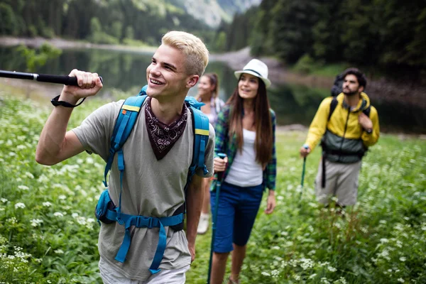 Group of happy people friends hiking together outdoor