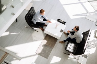 Ofis lobisinde fikirleri tartışmak iş adamları