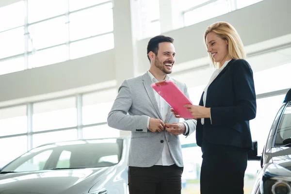Återförsäljare Som Visar Bilmodell För Den Potentiella Kunden Saloonen — Stockfoto