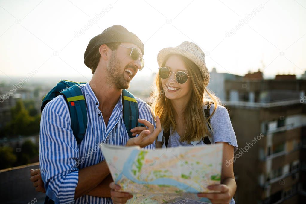 Young couple traveling with a map in the city