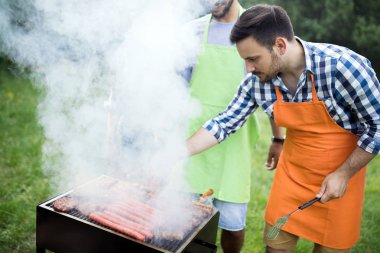 Birlikte gülen açık barbekü olan arkadaş grubu