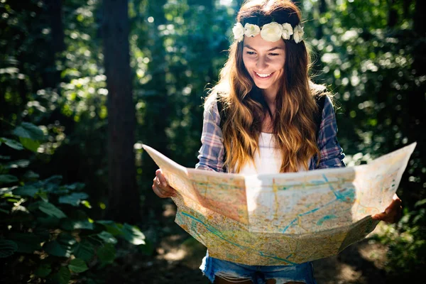 Hipster tourist woman with map hiking, lifestyle concept adventure, traveler with backpack