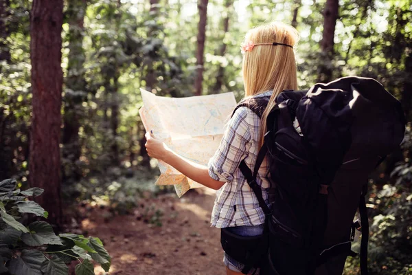 Hipster tourist woman with map hiking, lifestyle concept adventure, traveler with backpack