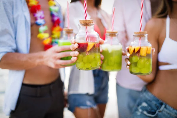 Group of happy friends partying and having fun on beach