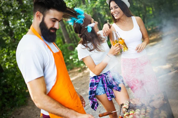 Friends having a barbecue party in nature while having a blast