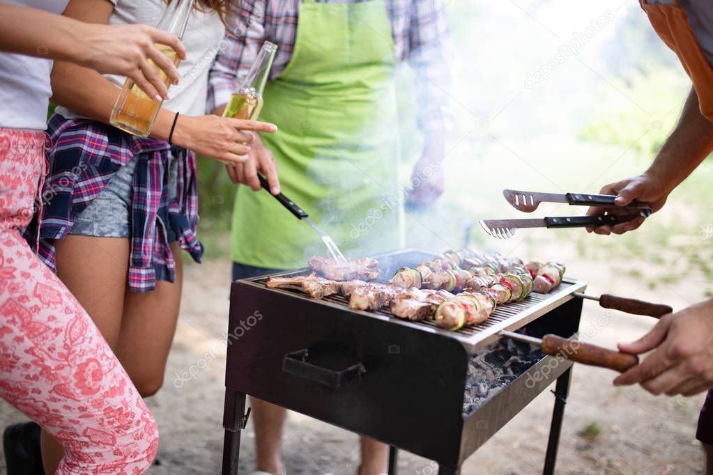 Assorted meat from chicken and pork and various vegetables on barbecue grill