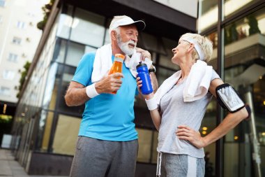 Yaşlı çift enerjilerini tazelemek ve su içmek için su içer.