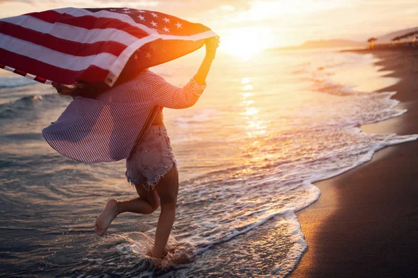 stock image Happy woman smiling and running on beach while celebrateing independence day and enjoying freedom in USA