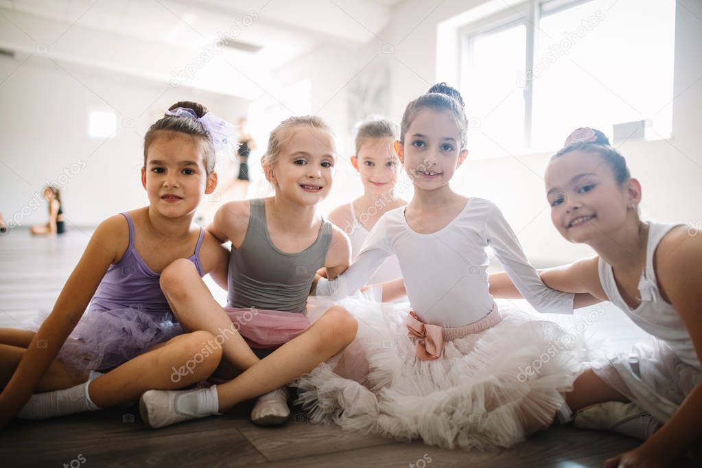 Group of fit children exercising ballet in studio together