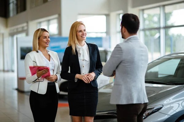 Professional gorgeous saleswoman at car dealership in formal wear. Super consultant or manager