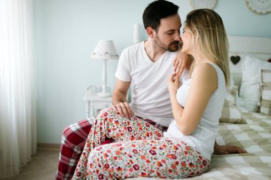 Yatak odasında genç çekici sevgi dolu çift portresi