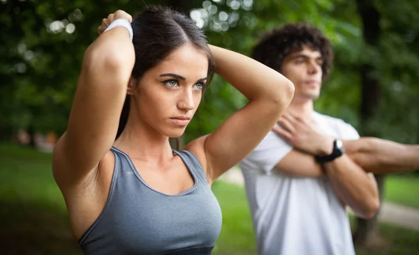 Couple friends jogging and running outdoors in nature