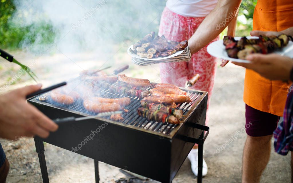 Assorted meat from chicken and pork and various vegetables on barbecue grill