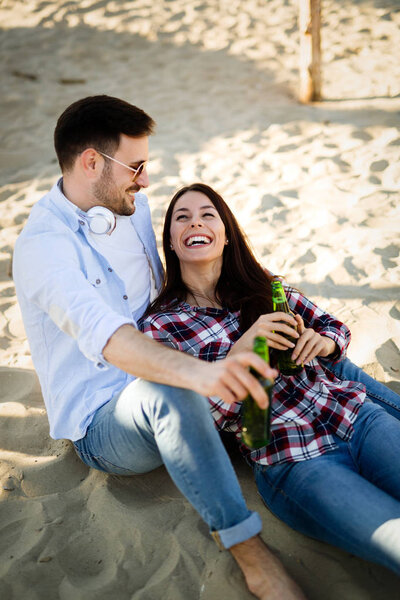 Cute lovers enjoying sunny day at the beach