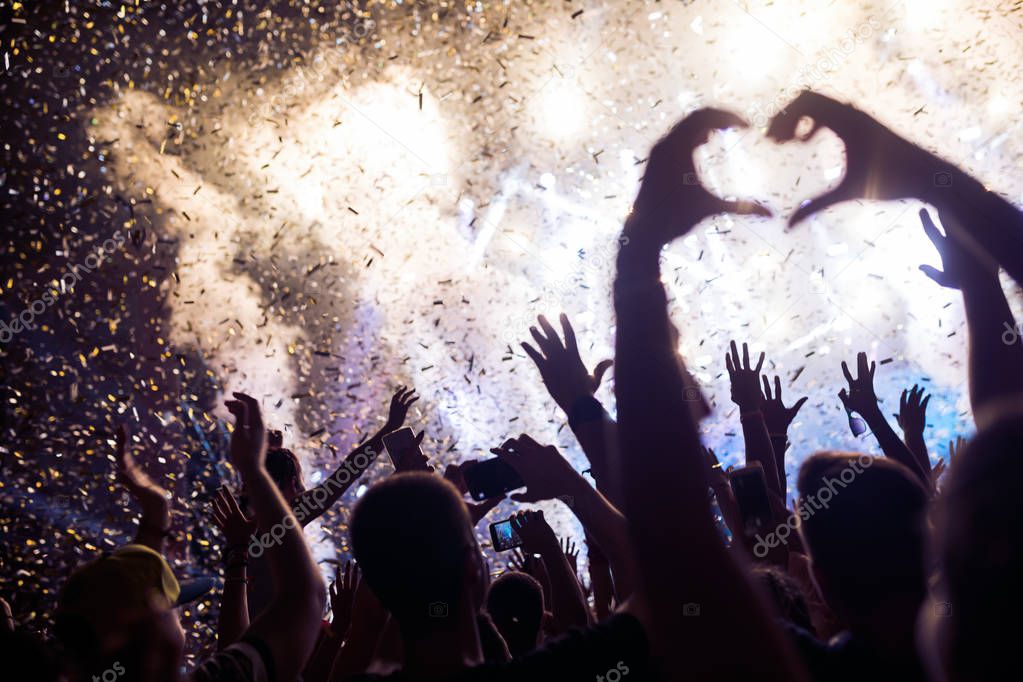 Portrait of happy dancing crowd enjoying at music festival