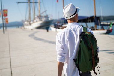 Tatil, tatil, seyahat, deniz ve insan kavramı. Sırt çantası ile Adam seyahat zevk