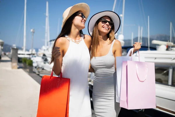Luxurious life for two women walking and shopping in a bay