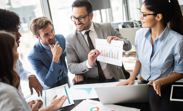Group of successful happy business people at work in office