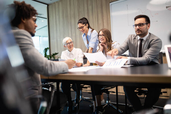 Successful group of business people at work in modern office