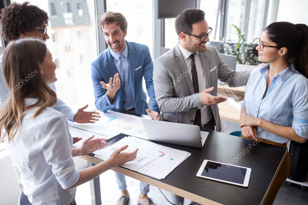 Group of successful happy business people at work in office