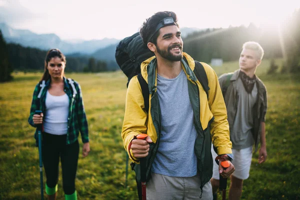 Successful Group of HappyYoung Friends on Mountain Top, Cheering