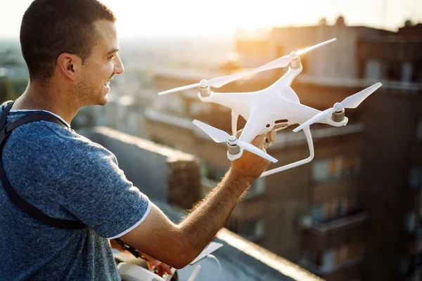 Man operating a drone with remote control outdoor