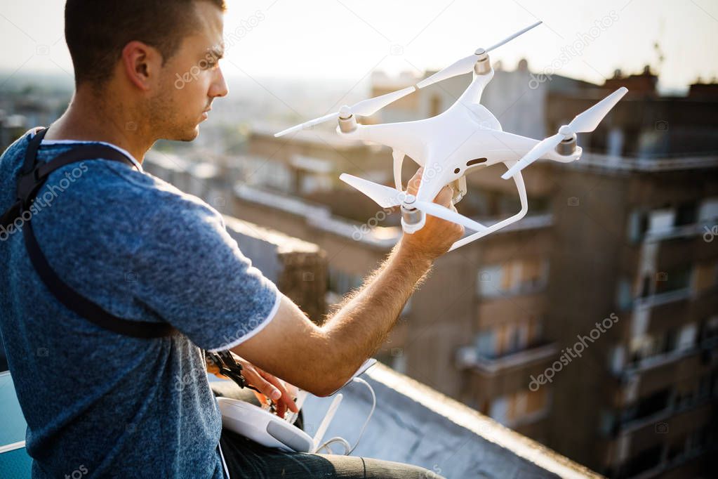 Man with drone flying at the city outdoor