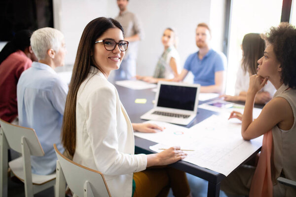 Group of successful happy business people at work in office
