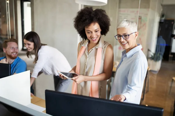 Young black woman working with tablet in office