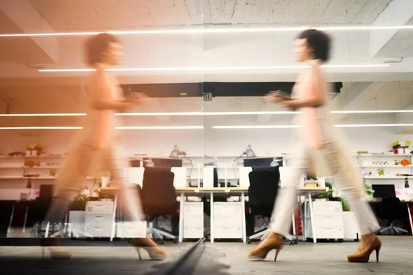 Professional business woman in motion with blur in business coworking office