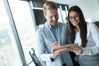 İş adamları ofiste dijital tablet kullanırken tartışıyor