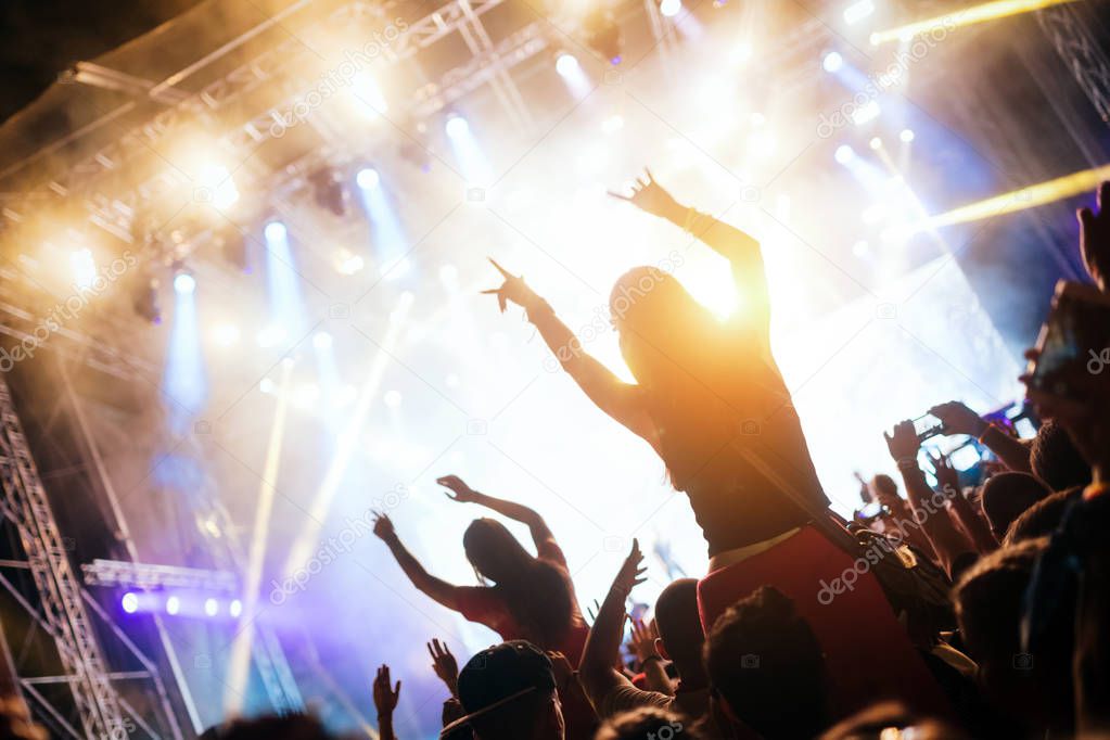 Portrait of happy dancing crowd enjoying at music festival