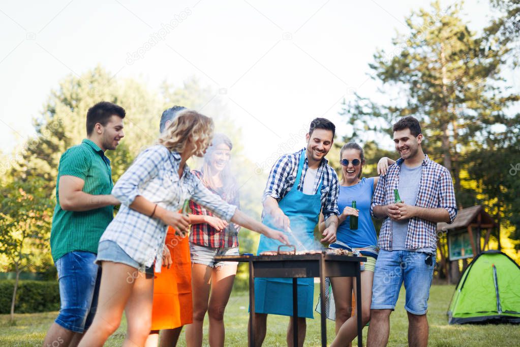 Young people enjoying barbecuing outdoor