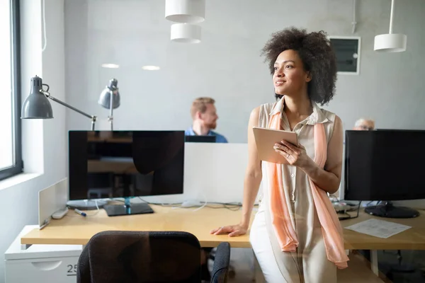 Young black woman working with tablet in office