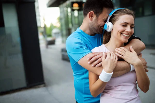 Exhausted sporty couple runners after fitness running workout outdoors