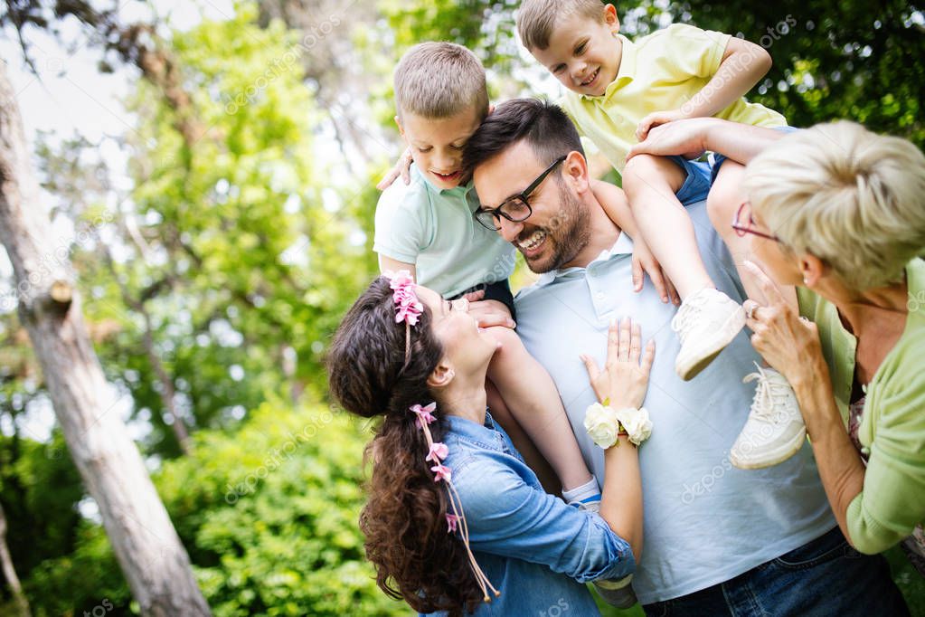 Happy family enjoying picnic with kids in nature