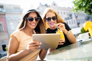 Tatil, turizm ve internet - cafe dışında tablet pc bakarak güzel genç kızlar