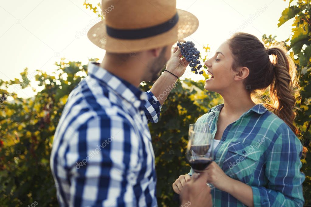 Couple in love working at winemaker vineyard and tasting wines