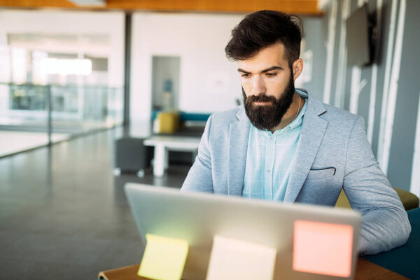 Young employee looking at computer monitor during working day