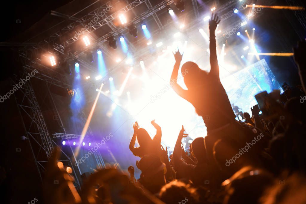 Portrait of happy dancing crowd enjoying at music festival