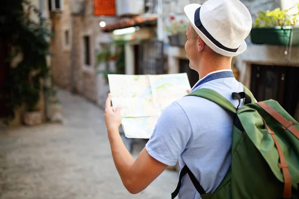 Genç adam yaz tatilinde gülümsüyor ve seyahat ediyor.