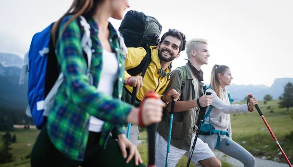 Group of friends on a mountain. Young people on mountain hike