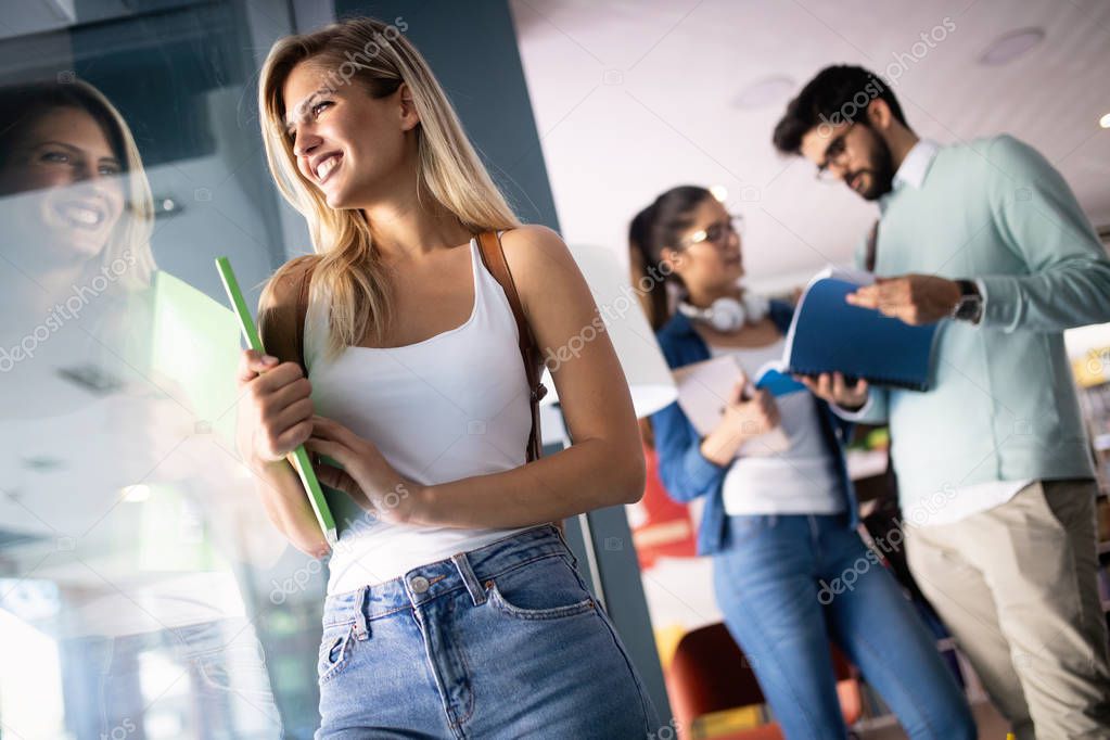 Happy group of friends studying together at university campus