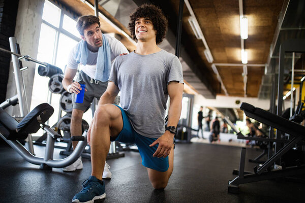 Young man doing workout with a personal trainer.