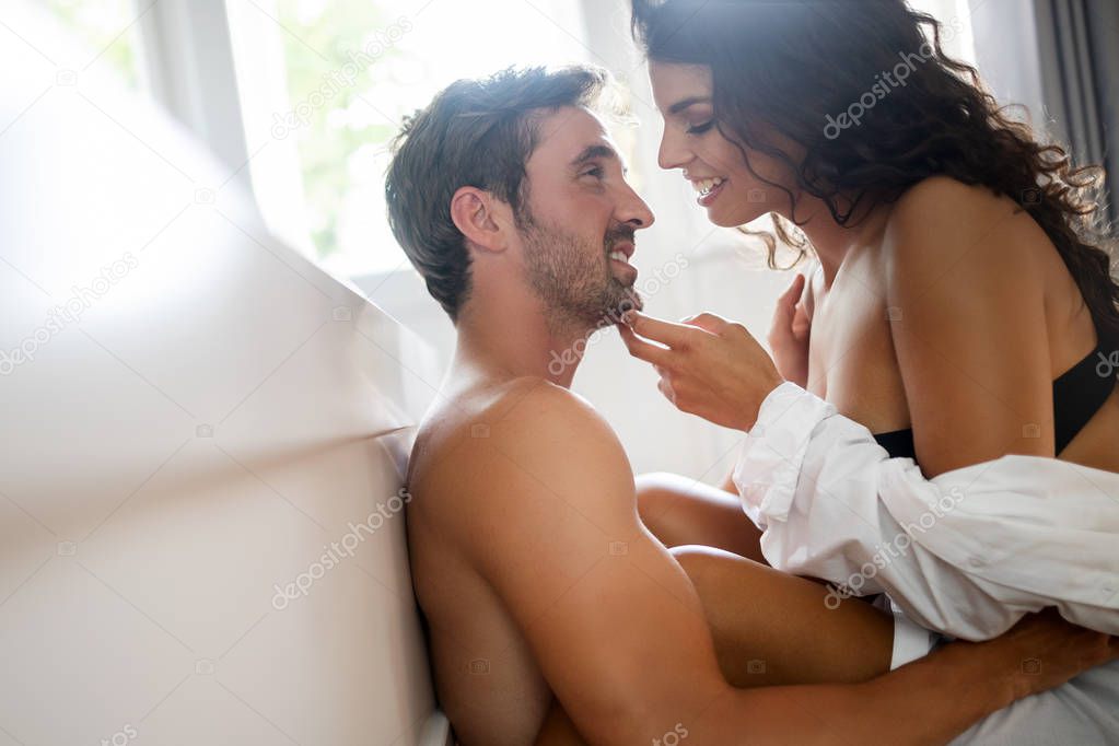 Young sexy hot couple in love hugging and kissing. Beautiful woman and handsome muscular man close to each other in erotic pose.